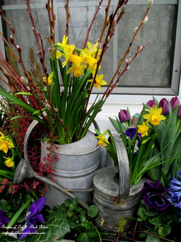 Close-up of the watering cans in the windowbox. https://lolajack-global.jp.net/diy-project-welcome-spring-time-to-change-the-window-boxes/